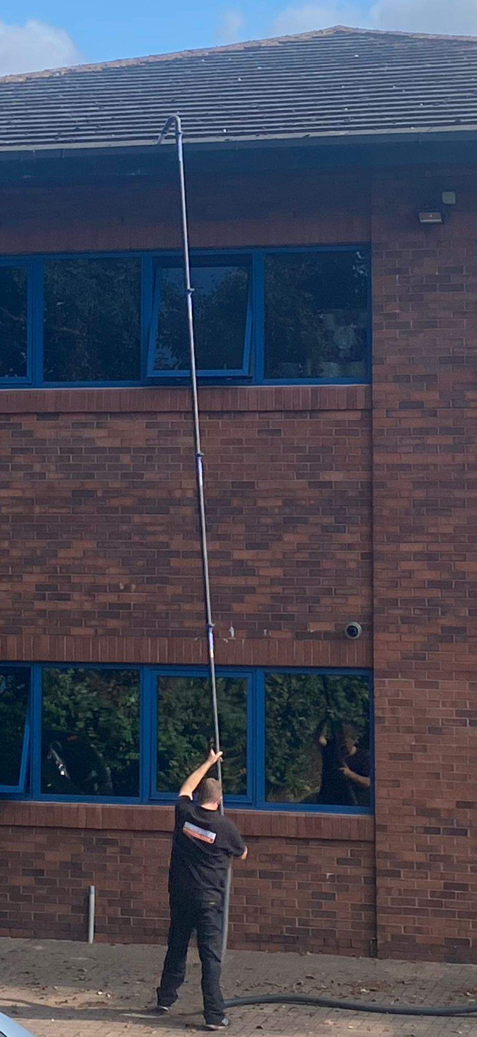 Dave Wood using professional water-fed pole system for streak-free window cleaning