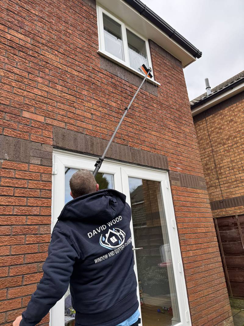 Dave Wood cleaning residential windows with professional water-fed pole system in South Manchester